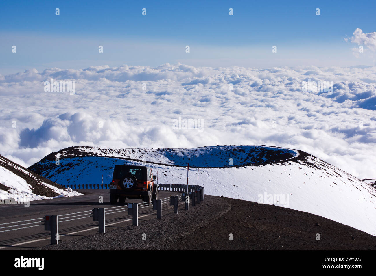 Car on Mauna Kea summit road, Pu`u Hau Kea cinder cone in background